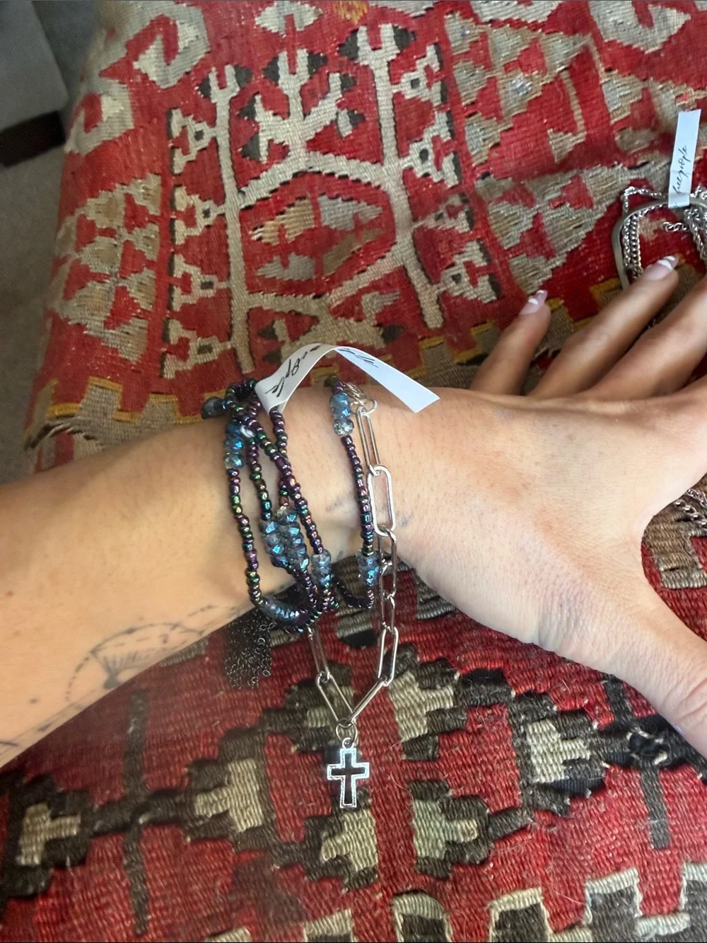 Free People iridescent blue-purple beaded bracelet with silver cross jewelry